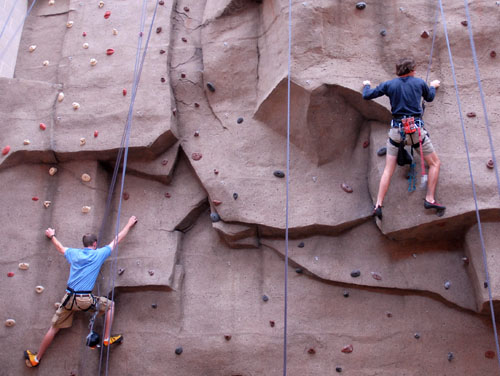 two rock climbers on climbing wall